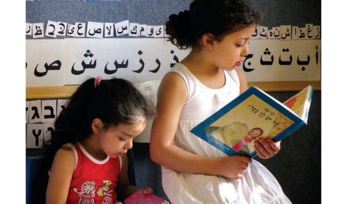 Barn leser sammen på den tospråklige skolen Hagar i Beersheba. (Illustrasjonsfoto: Jewish-Arab Education for Equality, via jpost.com) Barn leser sammen på den tospråklige skolen Hagar i Beersheba. (Illustrasjonsfoto: Jewish-Arab Education for Equality, via jpost.com)